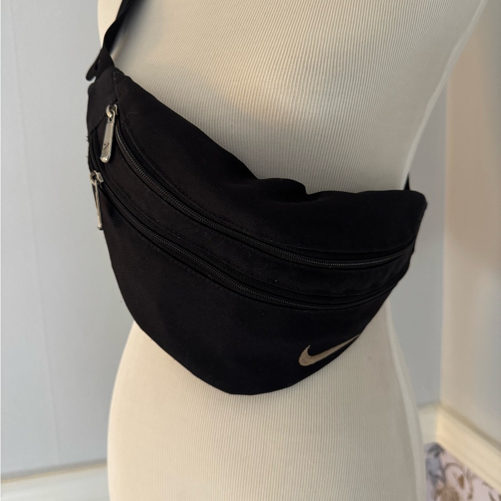 Nike Black Waist Bag with Beige Swoosh Accent.